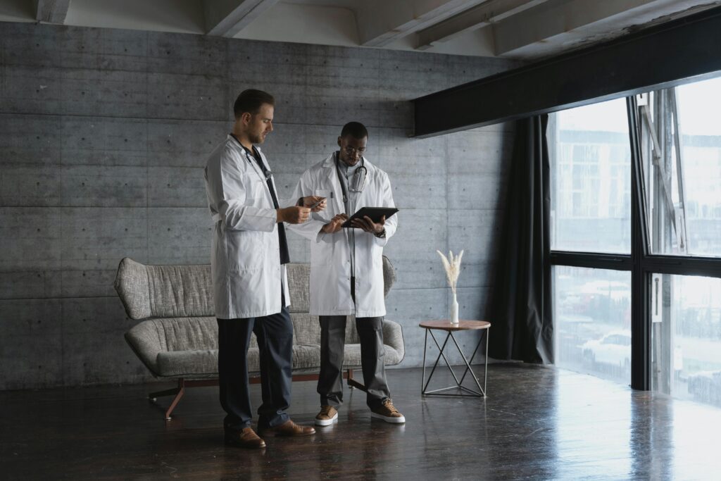 Two doctors standing in a modern room - photo credit miroshnichenko